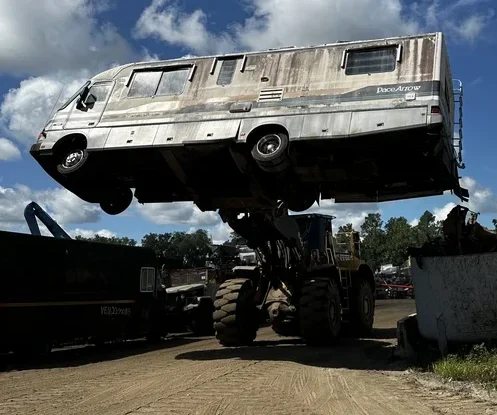 Loader lifting an RV (recreational vehicle), showing the process of elevating the vehicle