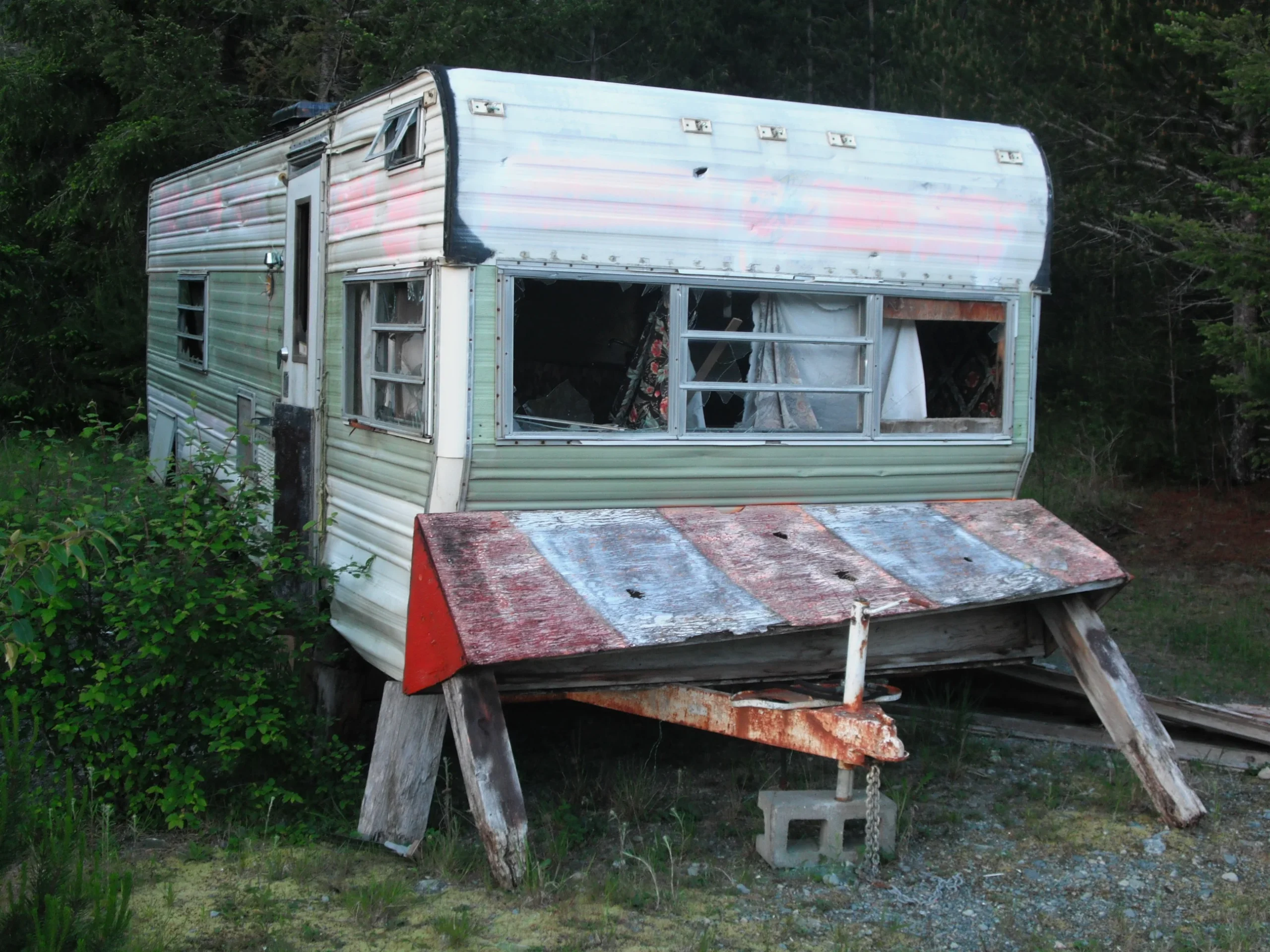 Old abandoned RV nestled in a dense forest