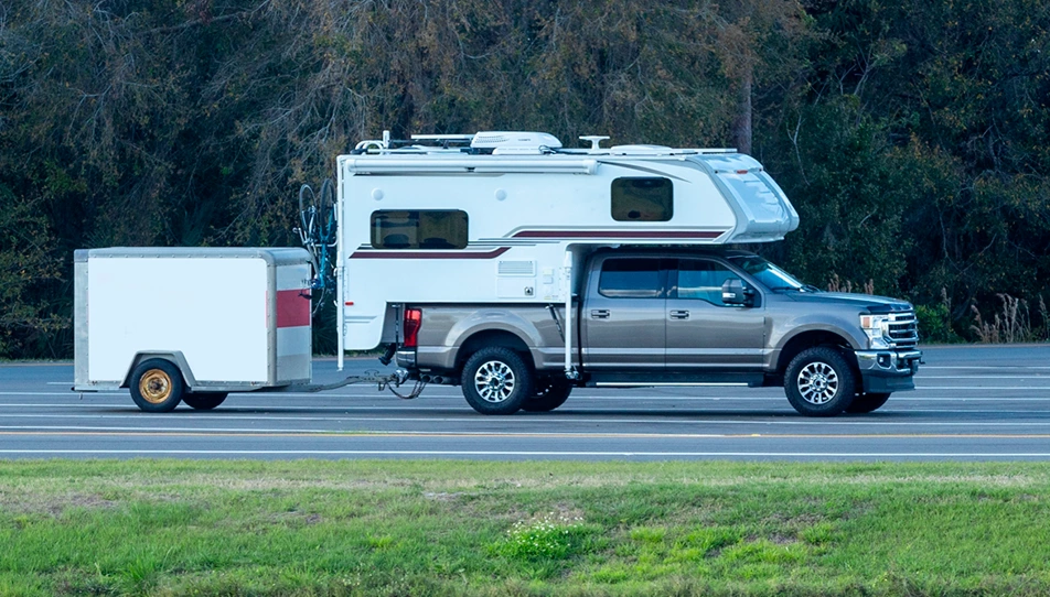 Truck camper being removed from a site